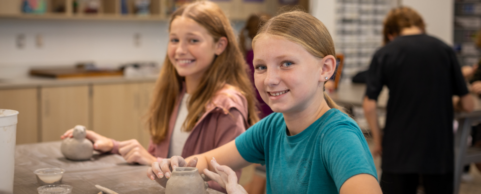 girls working with clay in art class